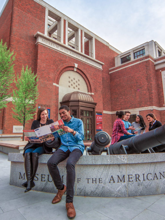 People hanging out outside the Museum of the American Revolution in Philadelphia