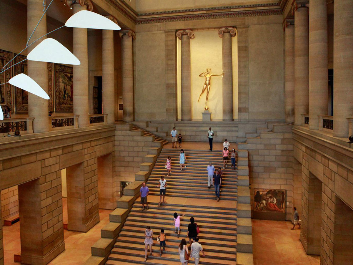 People walking up the steps in the Great Stair Hall at the Philadelphia Museum of Art