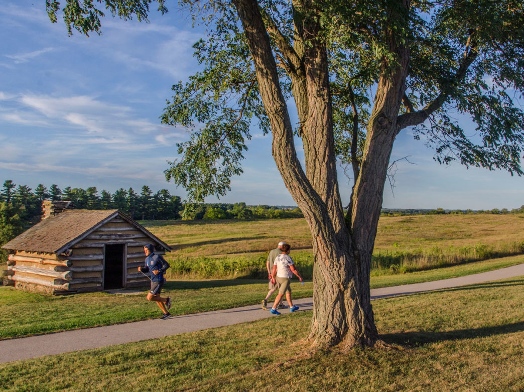 Runner and walkers in Valley Forge National Historical Park