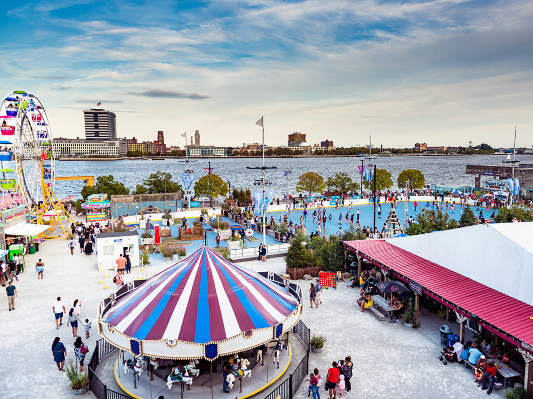 An aerial view of the roller skating rink, carousel and Ferris wheel at Blue Cross RiverRink Summerfest in Philadelphia
