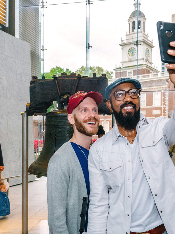 Couple posing for a selfie with the Liberty Bell in Philadelphia
