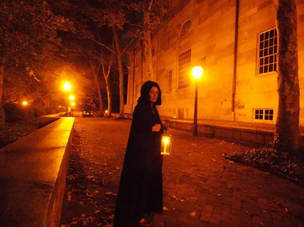 A tour guide in a cloak on a Ghost Tour of Philadelphia
