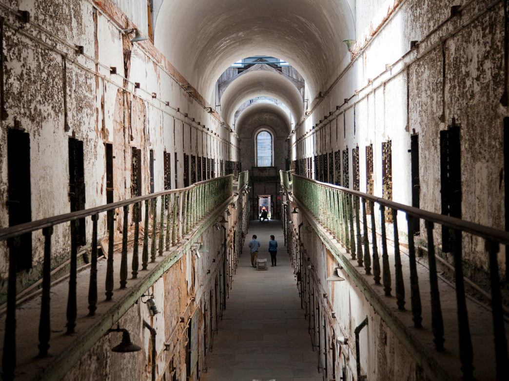 A look down a long hallway of prison cells at Eastern State Penitentiary in Philadelphia