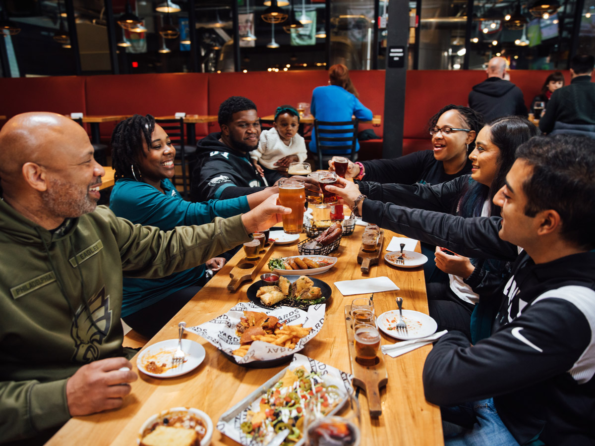 Group at Yards Brewing Company cheers over food
