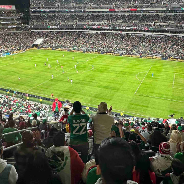 Crowds watch and cheer at a soccer game at Lincoln Financial Field.