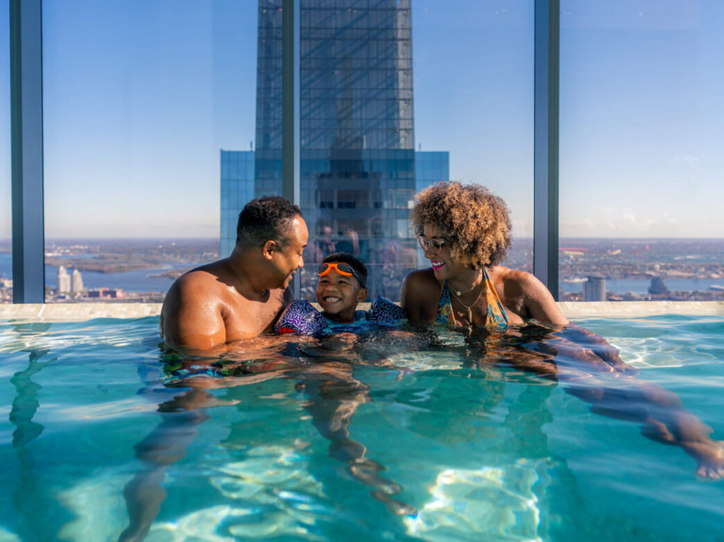 A family goes swimming at the infinity pool at the Four Seasons in Philadelphia.