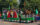 People on a float wave to the crowd during the Juneteenth Parade in Philadelphia. The float is decorated with green and red with "Honor the Ancestors" written on the side.