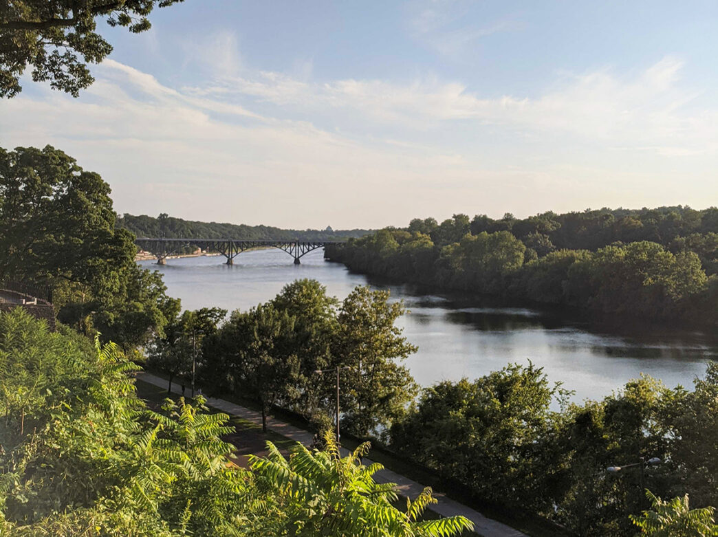An overlook over the Schuylkill River and Kelly Drive with the Belmont Plateau on the opposite side of the river.