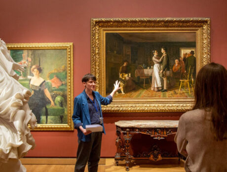 Aislinn Pentecost-Farren leads a guided tour through an art museum.