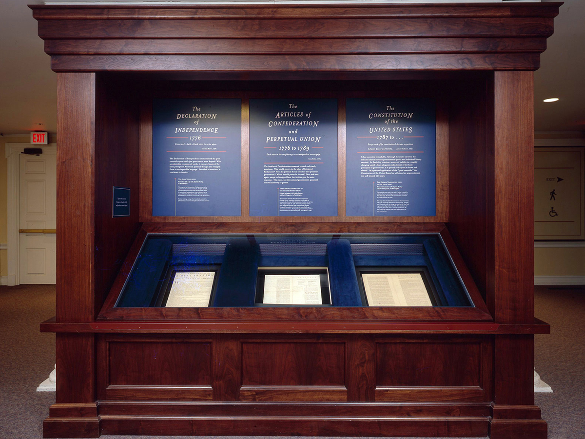 The nation's "Great Essentials", original printed copies of the Declaration of Independence, the Articles of Confederation, and the U.S. Constitution, are displayed in a wood cabinet in Independence Hall.
