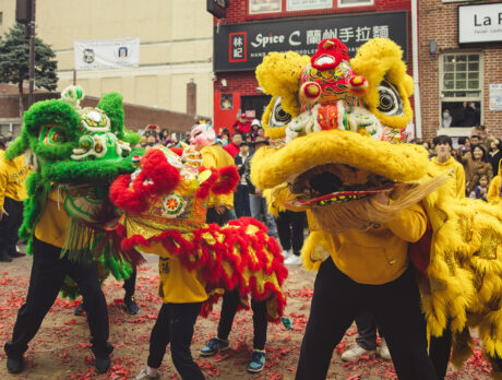 People gather to watch a performance of a traditional lion dance during the Lunar New Year Parade in Chinatown.