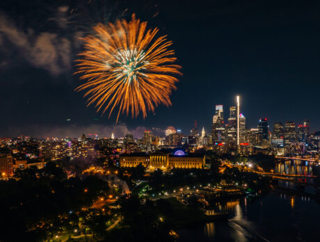 A large orange and gold firework erupts over the Philadelphia Museum of Art in Philadelphia.